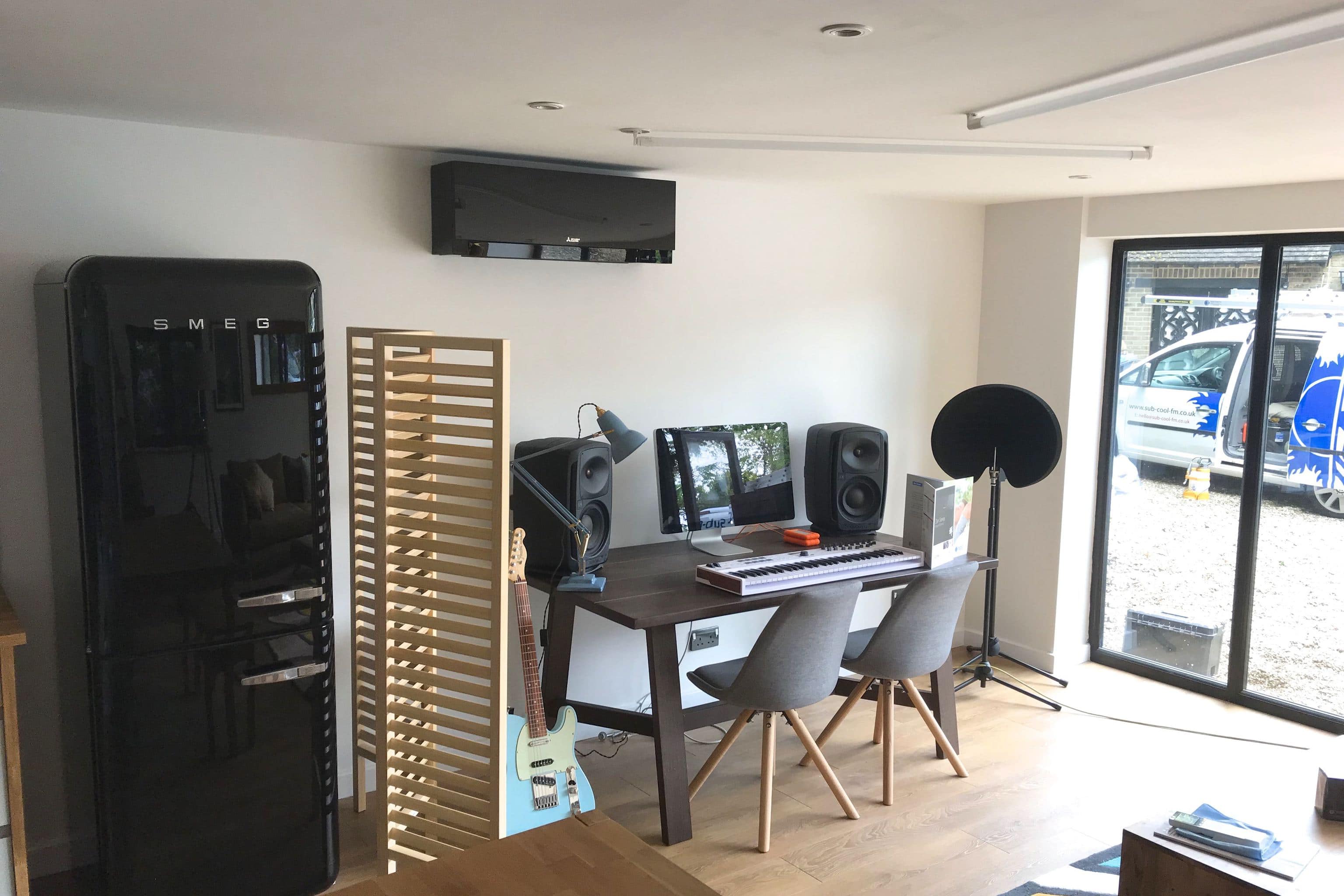 SubCool black wall unit in living space above desk
