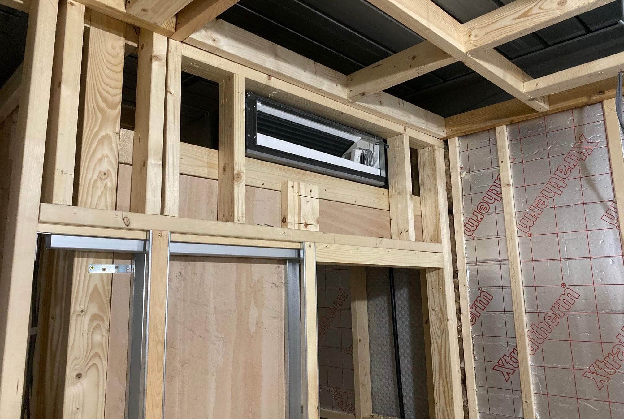 Ducted domestic air conditioning being fitted into ceiling building works in new build in Milner Street property fitted within furniture