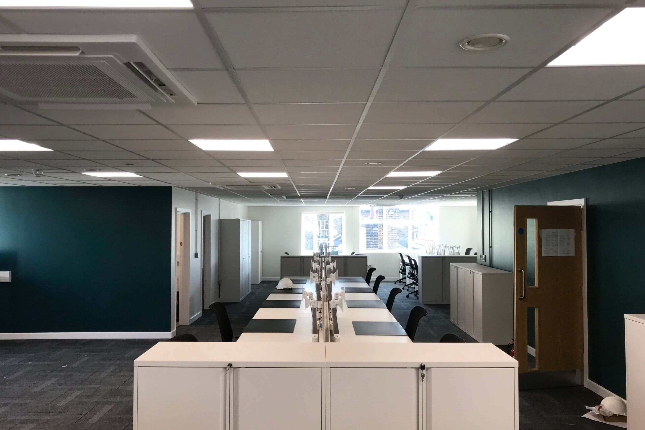 Norwood junction large commercial air conditioning solution by SubCool FM white cassette units in ceiling of office desk space