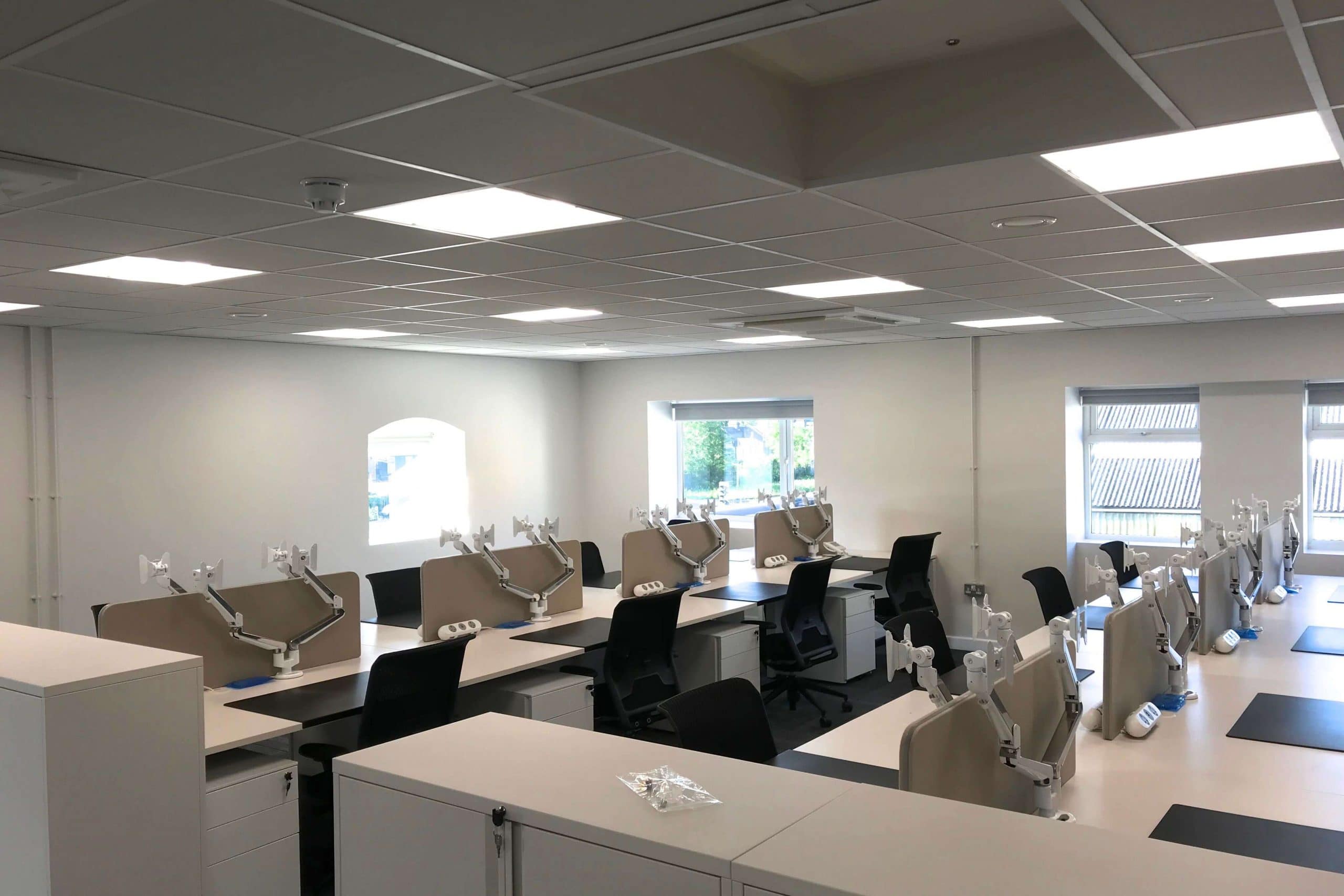 Norwood junction large commercial air conditioning solution by SubCool FM white ceiling cassette in multi-desk office or hot desk area