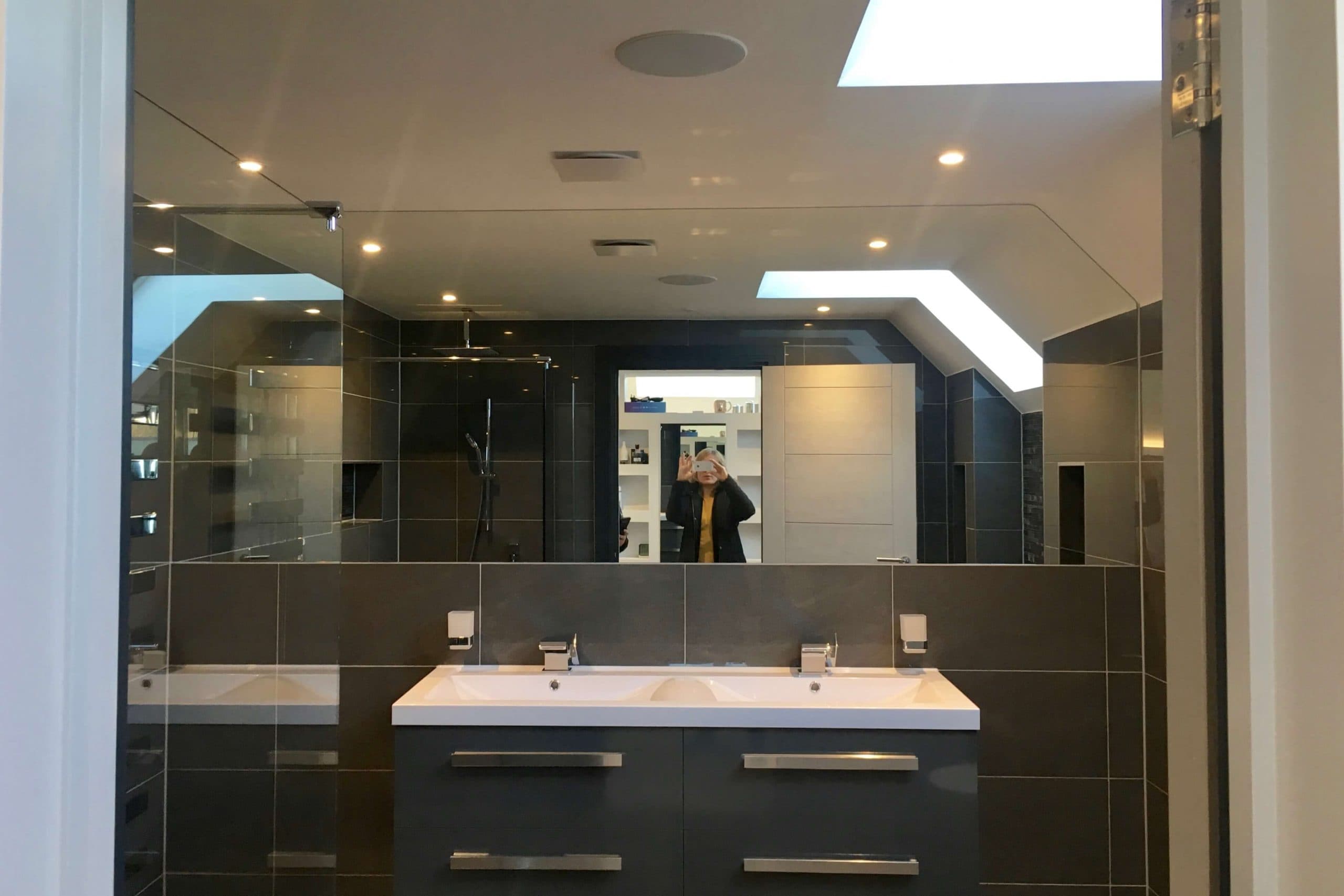 Bathroom in Scandia Hus new build with ceiling squares hidding MVHR system by SubCool FM