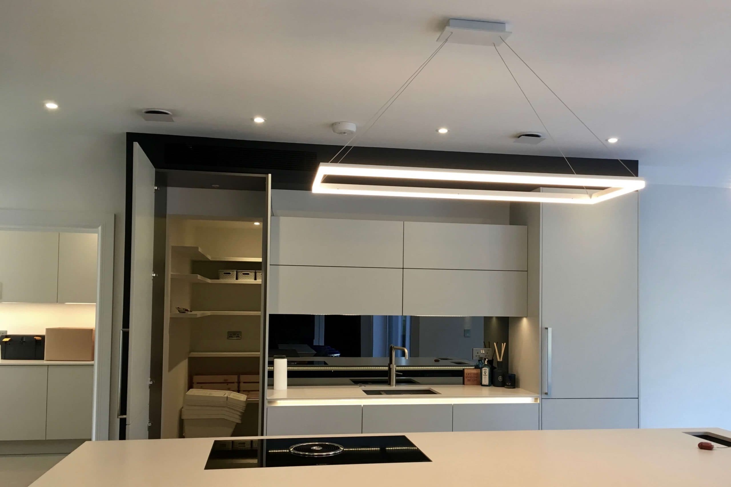Scandia Hus new build kitchen with invisible Mitsubishi air con grill and MVHR system by SubCool FM hidden door to chill room open