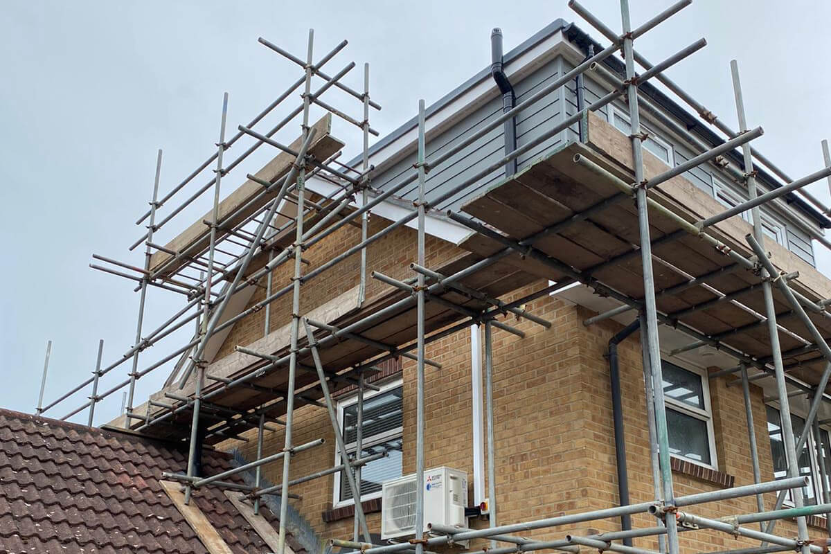 Littlehampton, West Sussex loft conversion air conditioning installation external unit amongst scaffolding SubCoolFM
