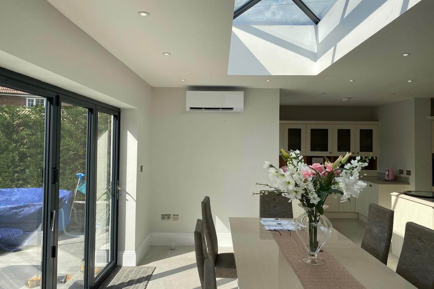 SubCoolFM wall mounted air conditioning in Staines kitchen living space extension showing end of extension by dining area and windows