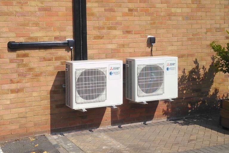 Mitsubishi electric 2 domestic external air conditioning units with neat black trunking