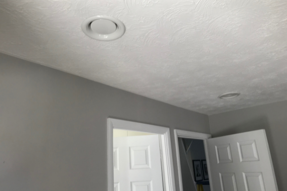 White ceiling duct above doors